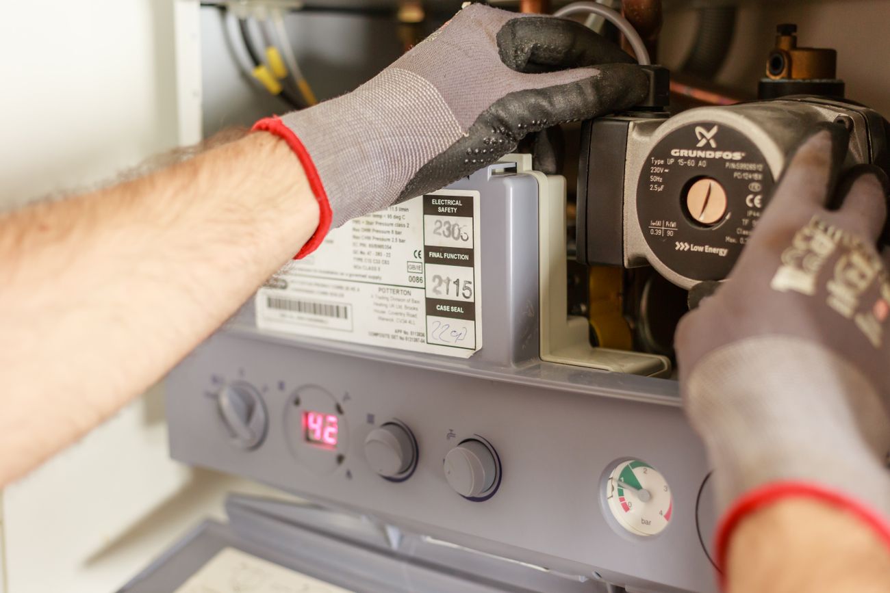 A Gas Safe registered engineer servicing a boiler